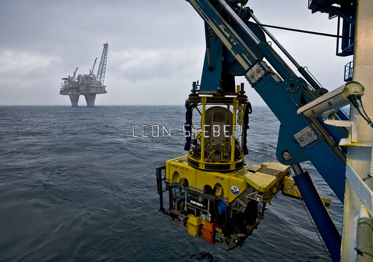 MV Geofjord launching it's ROV for a pipeline survey with Troll A oil rig platform in the background