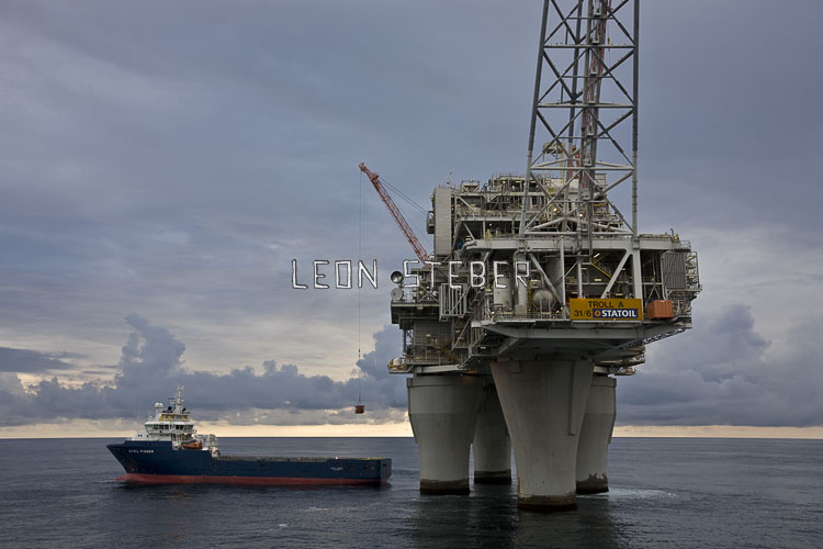 This stock oil rig photo shows the Stril Pioneer supply vessel alongside the Troll A platform