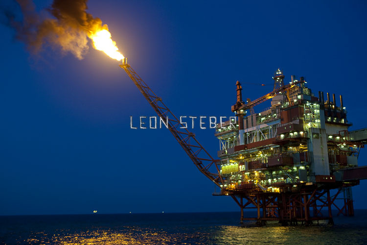 Oil rig stock photography of the Norwegian BP Valhall Oil Rig at night with a gas flare.