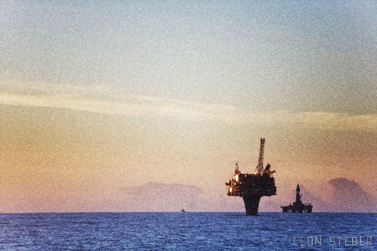 Draugen oil rig, photo taken from the M/V Geofjord. Draugen is an oil field in the Norwegian Sea at a sea depth of 250 metres. The field has been developed with a concrete fixed facility and integrated topside. Stabilised oil is stored in tanks in the base of the facility. Two pipelines transport the oil from the facility to a floating loading buoy.  This oil rig stock photo was taken from the M/V Geofjord. Originally owned and operated by DOF Subsea, the Geofjord is now owned by Jas Marine in Malaysia.